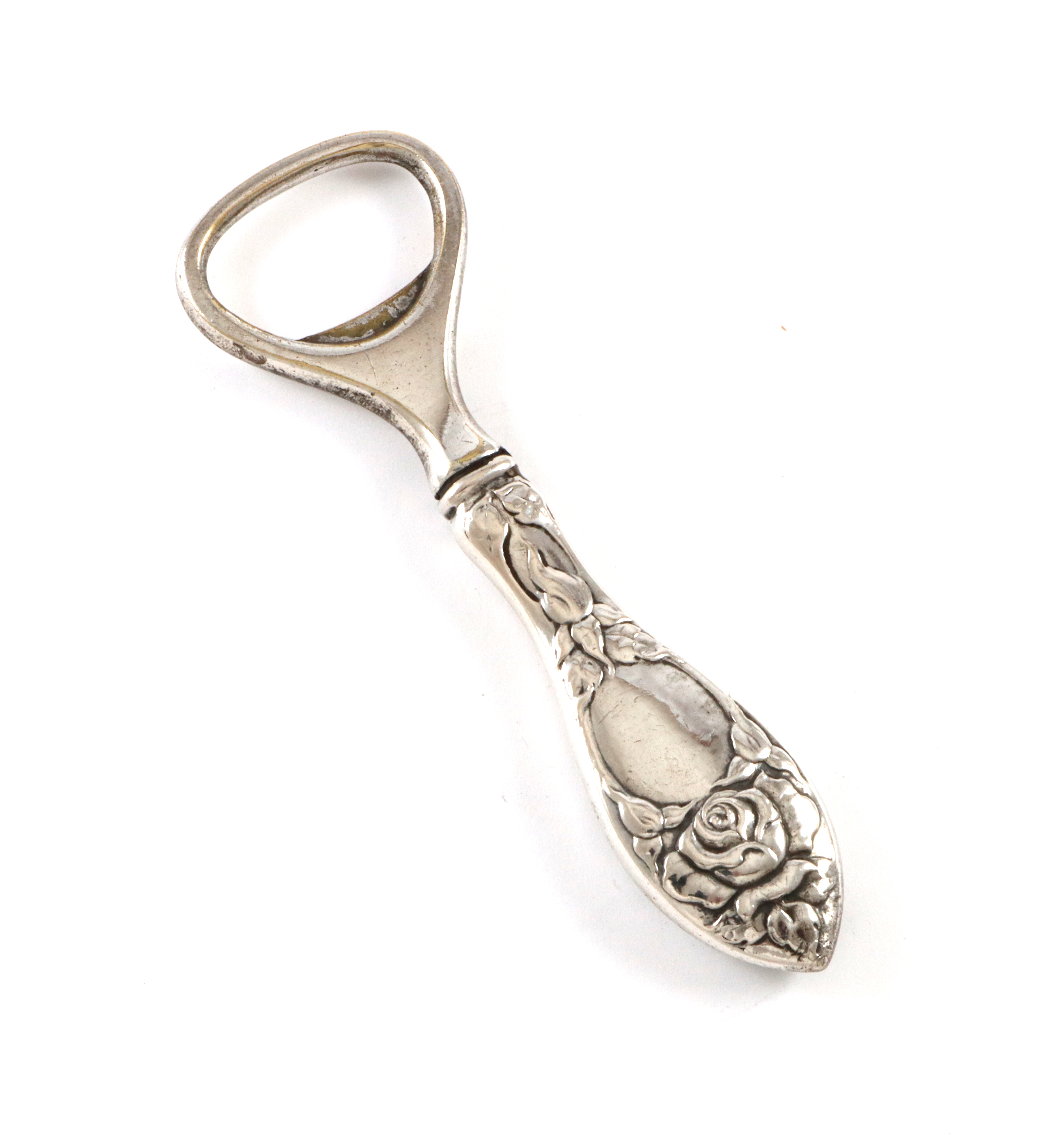 Rosemønster flaskeåpner i sølv.